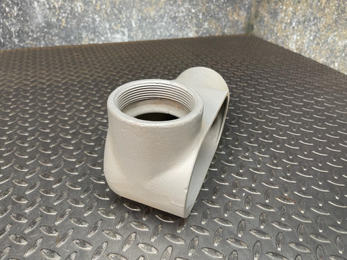 A 3-inch Appleton LL conduit body from Obtainium Science and Surplus, presented from an angle, with focus on the circular opening and metallic surface.