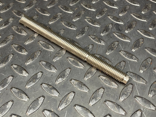 Hilti HAS-R 304 SS Anchor Rod - 1/2"x 6 1/2" from Obtainium Science and Surplus: Close-up of a single threaded rod on a textured metal surface, showing the fine threading detail.