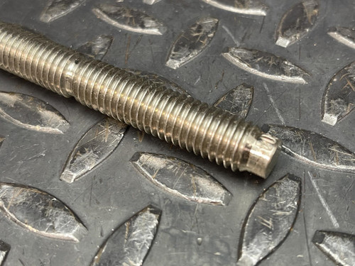 Hilti HAS-R 304 SS Anchor Rod - 1/2"x 6 1/2" from Obtainium Science and Surplus: Close-up of the end of a threaded rod, highlighting the precise threading and cut end against a textured metal background.