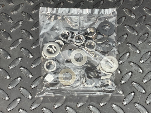 Hilti HAS-R 304 SS Anchor Rod - 1/2"x 6 1/2" from Obtainium Science and Surplus: A plastic bag filled with various sizes of washers and nuts, placed on a textured metal surface.