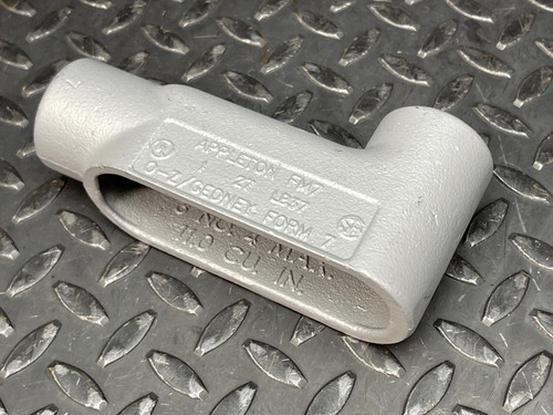 A single 1" Appleton LB Conduit Body from Obtainium Science and Surplus, shown on a diamond plate surface.