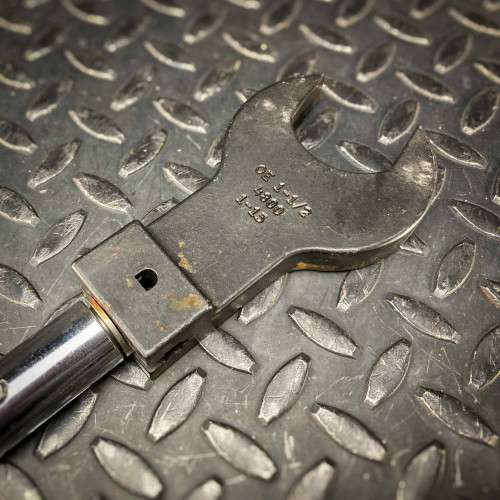 Close-up of another head attachment on the Sturtevant Richmont Exacta 2 digital torque wrench. This attachment is also designed for precise torque applications and securely fits onto the handle. It features engraved specifications and is set against a textured metal surface, available from Obtainium Science & Industry Surplus.