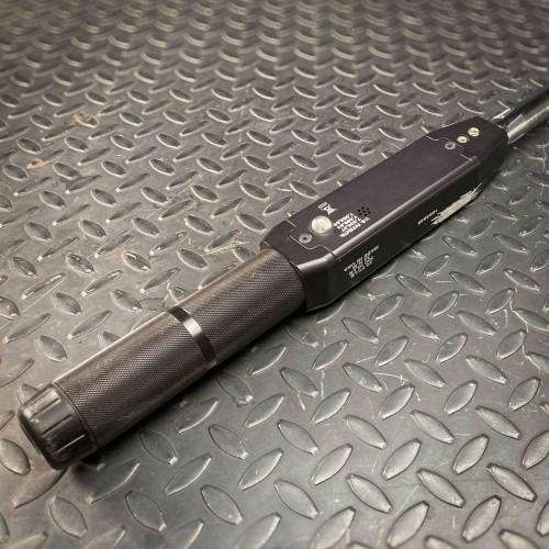 A rear view of the Sturtevant Richmont Exacta 2 digital torque wrench, focusing on the textured grip handle and the back panel. The sturdy handle ensures a firm grip, while the back panel includes various markings and a small metal component, showcasing the tool's robust design available from Obtainium Science & Industry Surplus.