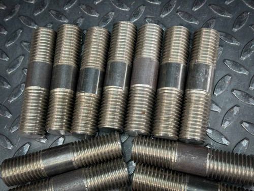 A set of B7 stud bolts arranged in two rows, highlighting the threading details and uniformity. These bolts are part of a 12-pack, each measuring 4.5 inches in length and 1 inch in diameter with 8 UNC threading. Available from Obtainium Science & Industry Surplus.