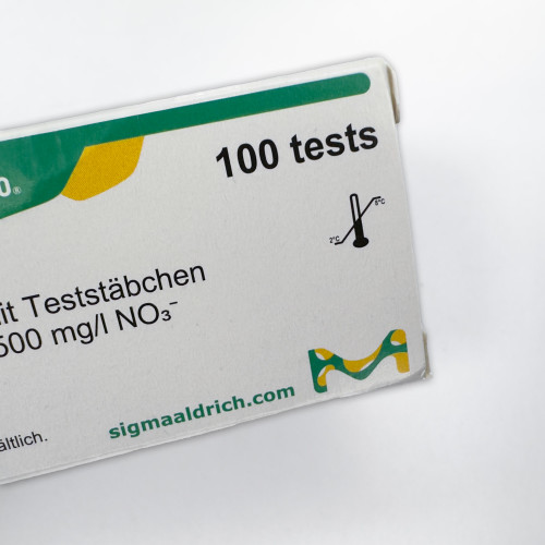 A close-up of the MQuant Nitrate Testing Strips box, highlighting the label for 100 tests with measurement capabilities up to 500 mg/l NO3-. The box also shows the Sigma-Aldrich logo and website. Available from Obtainium Science & Industry Surplus.