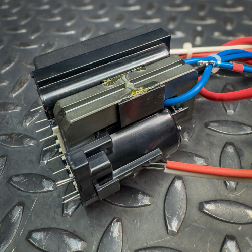 Side angle of a vintage CRT monitor flyback transformer from Obtainium Science & Industry Surplus, displaying its intricate wiring and components.