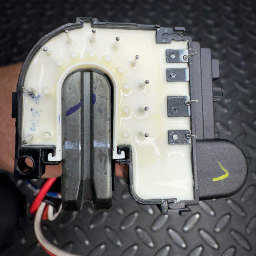 A vintage CRT monitor flyback transformer from Obtainium Science & Industry Surplus, featuring a detailed view of the white and metallic internal components.