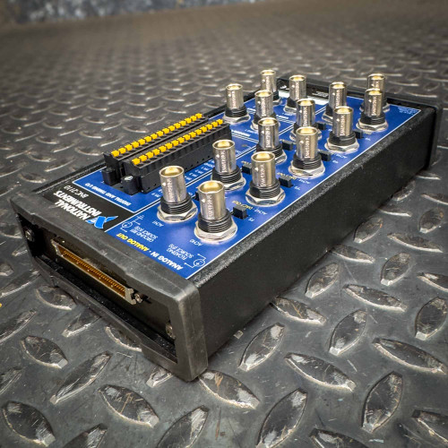 Angled view of the National Instruments BNC-2110 terminal block from Obtainium Science and Surplus, showcasing the connectors and the device’s structure.