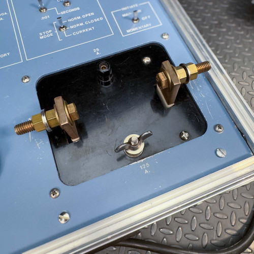A close-up view of the terminal connectors and a toggle switch on the Megger Multi-Amp CB-832 Circuit Breaker Tester.