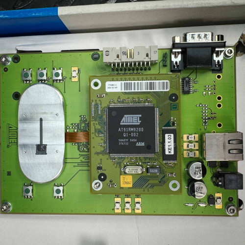 Close-up image of the ATMEL Biometric FingerChip circuit board from the Obtainium Science Surplus Store, highlighting the central ARM9 chip and surrounding electronic components.