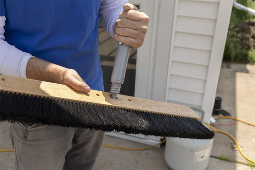 Person attaching MARSHALLTOWN push button handle adapter to a broom