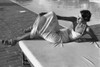 Elegant Tanning model at the pool with jeweled shoes and a slip dress Elegant Tanning model at the pool with jeweled shoes and a slip dress