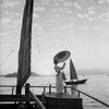 Fragrant Harbor Hong Kong by Gleb Derujinsky | Vintage Fashion Photo | Woman wearing white on a dock in Fragrant Harbor Hong Kong