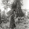 Fashion shot of a model in front of a Buddha by Gleb Derujinsky