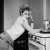 pre-fame Madonna leans against her stove in her east village flat