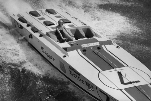 On the water fashion shoot with model racing on a cigarette boat