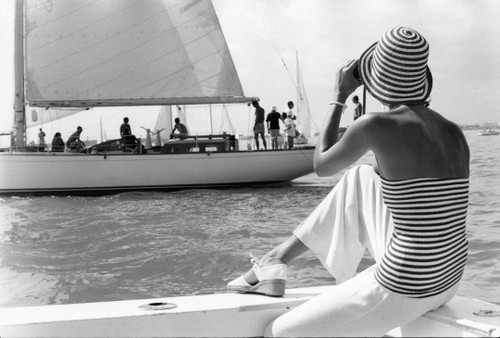 1970's fashion shoot on the water with sail boats