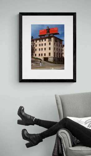 Elvis Costello, This Year\'s Model Billboard Photo by Robert Landau framed by arm chair.