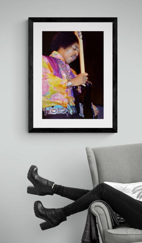 Jimi Hendrix #3 by Jeffrey Mayer wailing on his guitar, framed photo by arm chair