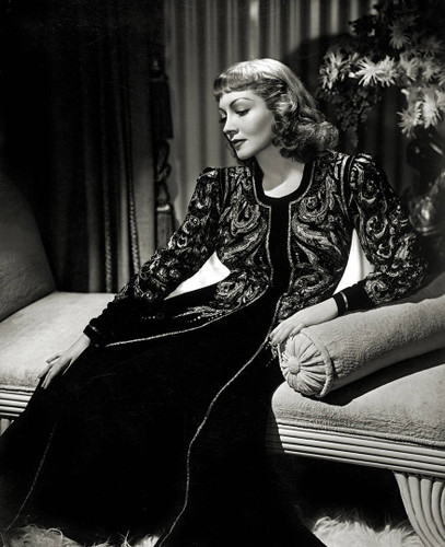Claudette Colbert in black gown by George Hurrell.