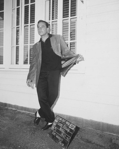 Gene Kelly wardrobe test shot for Marjorie Morningstar.\nGene Kelly does a little vamping for the wardrobe department in this charming test shot for Marjorie Morningstar, the Warner bros. adaptation of Herman Wouk’s novel. In this role, Kelly reminded everyone that he had serious acting chops, and wasn’t just a song and dance man -- although he was certainly that in spades. Howard Shoup, who received sole credit for costumes was known for gowns and Natalie Wood (Kelly’s co-star) looks even more stunning than usual. At the time of filming, Shoup is working at Warner and running his own boutique in Beverly Hills.