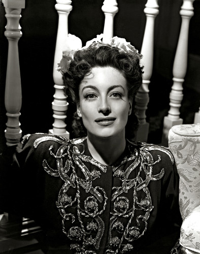 Joan Crawford in a black embellished dress, glamour shot by George Hurrell