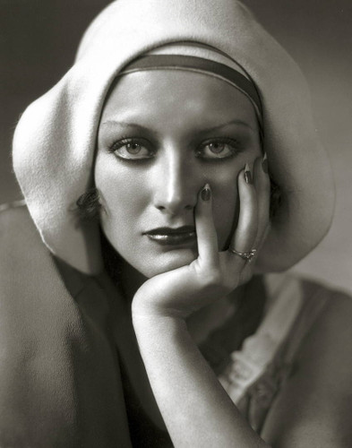 Joan Crawford in white cap portrait shot by George Hurrell.