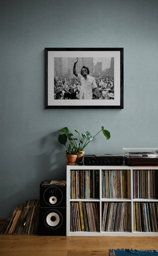 James Brown #1 by Richard E. Aaron | Classic Rock Photo | Limited Edition Print | 1979 in Harlem | James Brown smiling and waving in front of a crowd in Harlem | Framed in black in a music room.