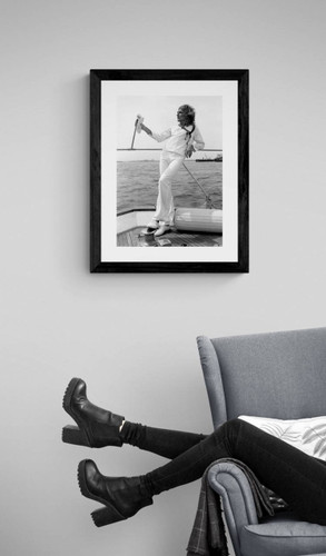 Rod Stewart #1 by Richard E. Aaron | Classic Rock Photo | Limited Edition Print| Rod enjoying some down time on a yacht | Displayed with a black frame near a reading chair.