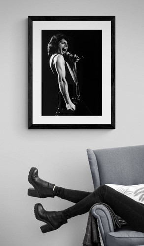 Queen # 12 | Freddie Mercury by Richard E. Aaron | Classic Rock Photo | Limited Edition Print | Framed in black and displayed by a reading chair.