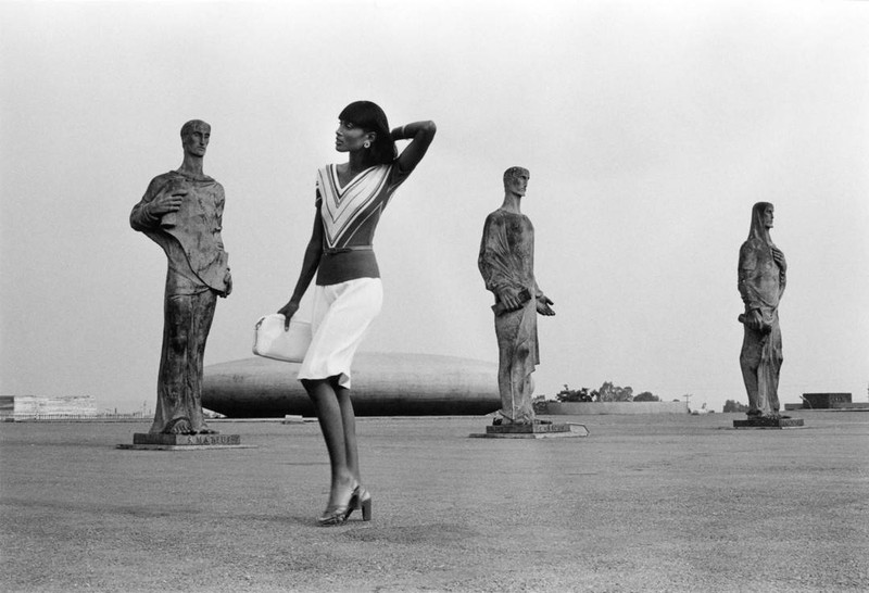 Fashion shoot with model surrounded by statues