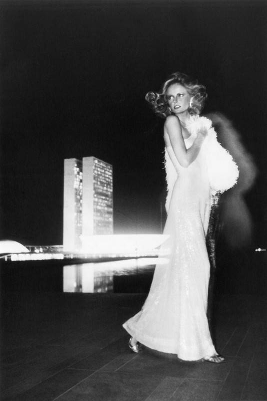 1970's super model Cheryl Tiegs in glittering sequin gown at a night time outdoor fashion shoot with reflections in the pool