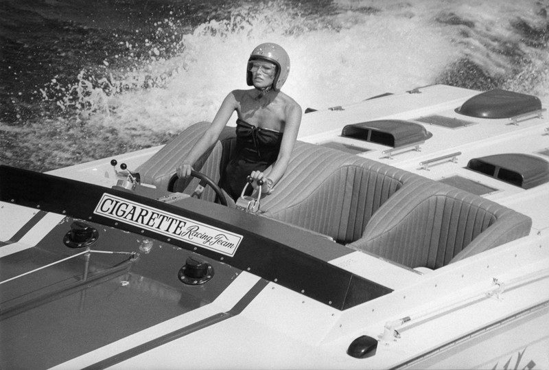 1970's fashion shoot racing on the water with a cigarette boat