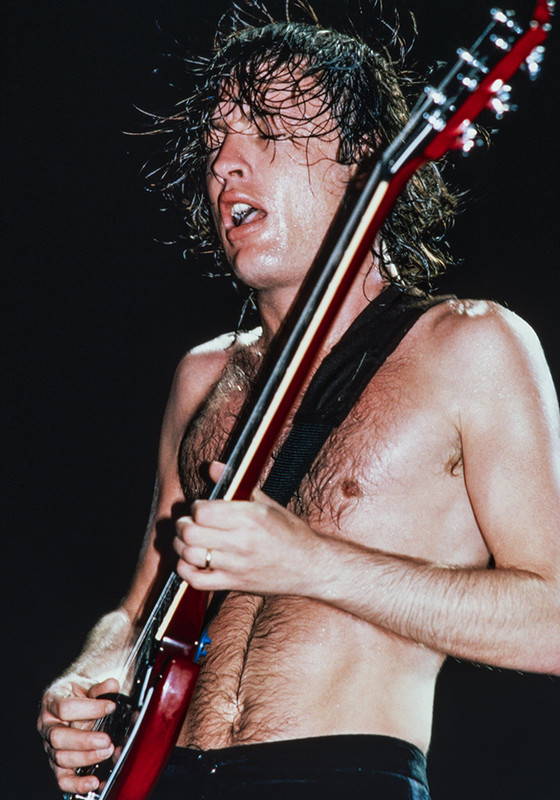 Photograph of Angus Young, lead guitar for AC/DC in Concert by Jeffrey Mayer
