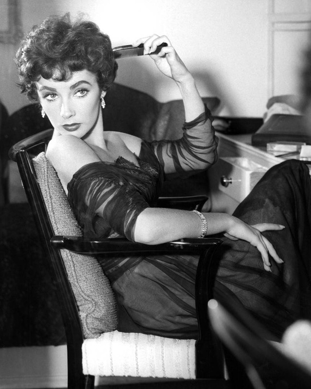 Elizabeth Taylor relaxes in her dressing room and lights up a little star wattage for the still camera.