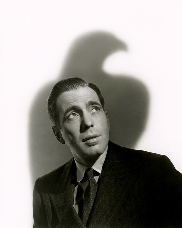 Dramatic portrait of Humphrey Bogart with a shadow of the falcon by Scotty Melbourne, Maltese Falcon, 1941