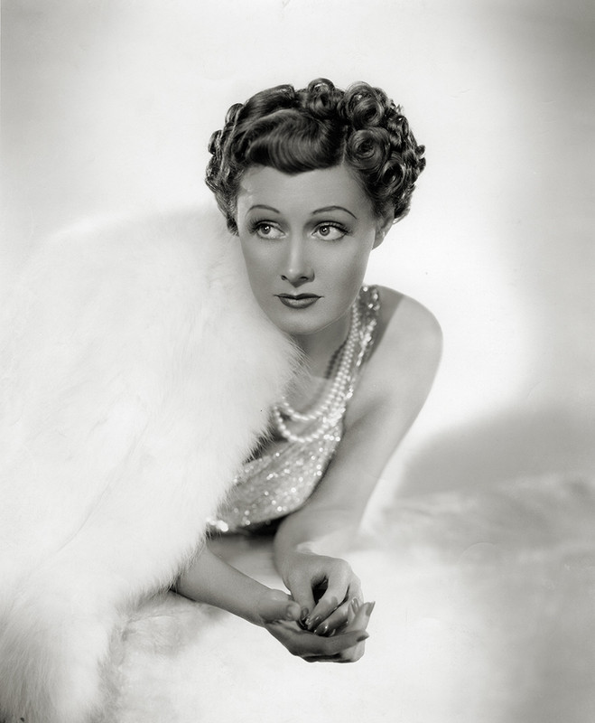 Hollywood Glamour photo of Irene Dunne in white fur and sequin gown by Ernest Bachrach, 1938.