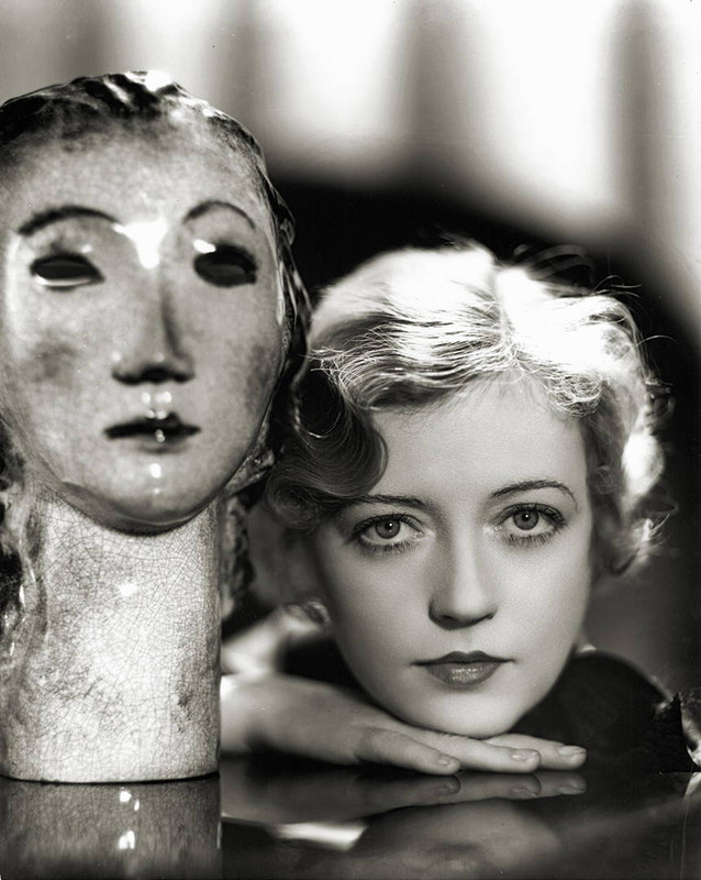 Unique shot of Marion Davies next to a sculpture of a woman\'s head by George Hurrell, 1930