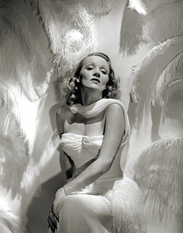 Stunning shot of Marlene Dietrich with white feathers by George Hurrell.