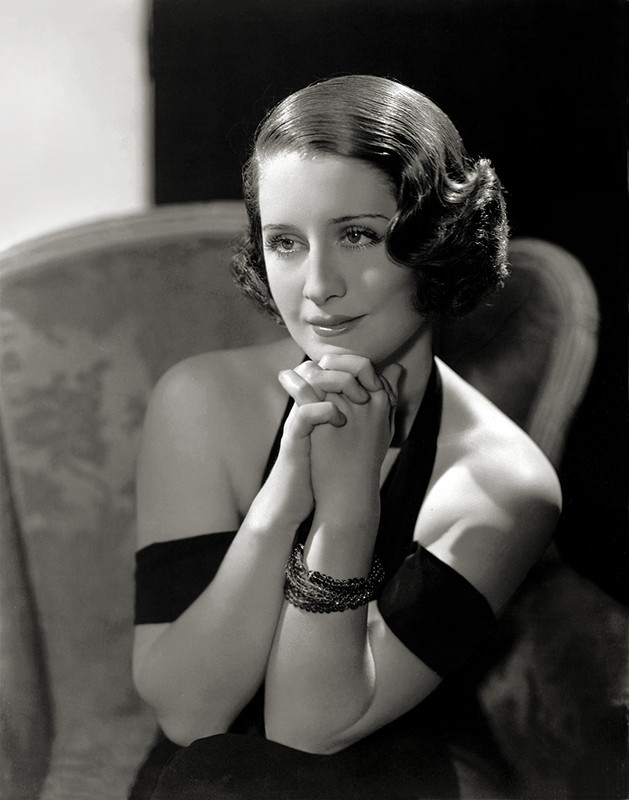 Norma Shearer in an off the shoulder black gown, shot by George Hurrell.