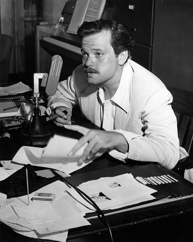 This interesting photograph captures Orson Welles, the genius of theater and film, hard at work.