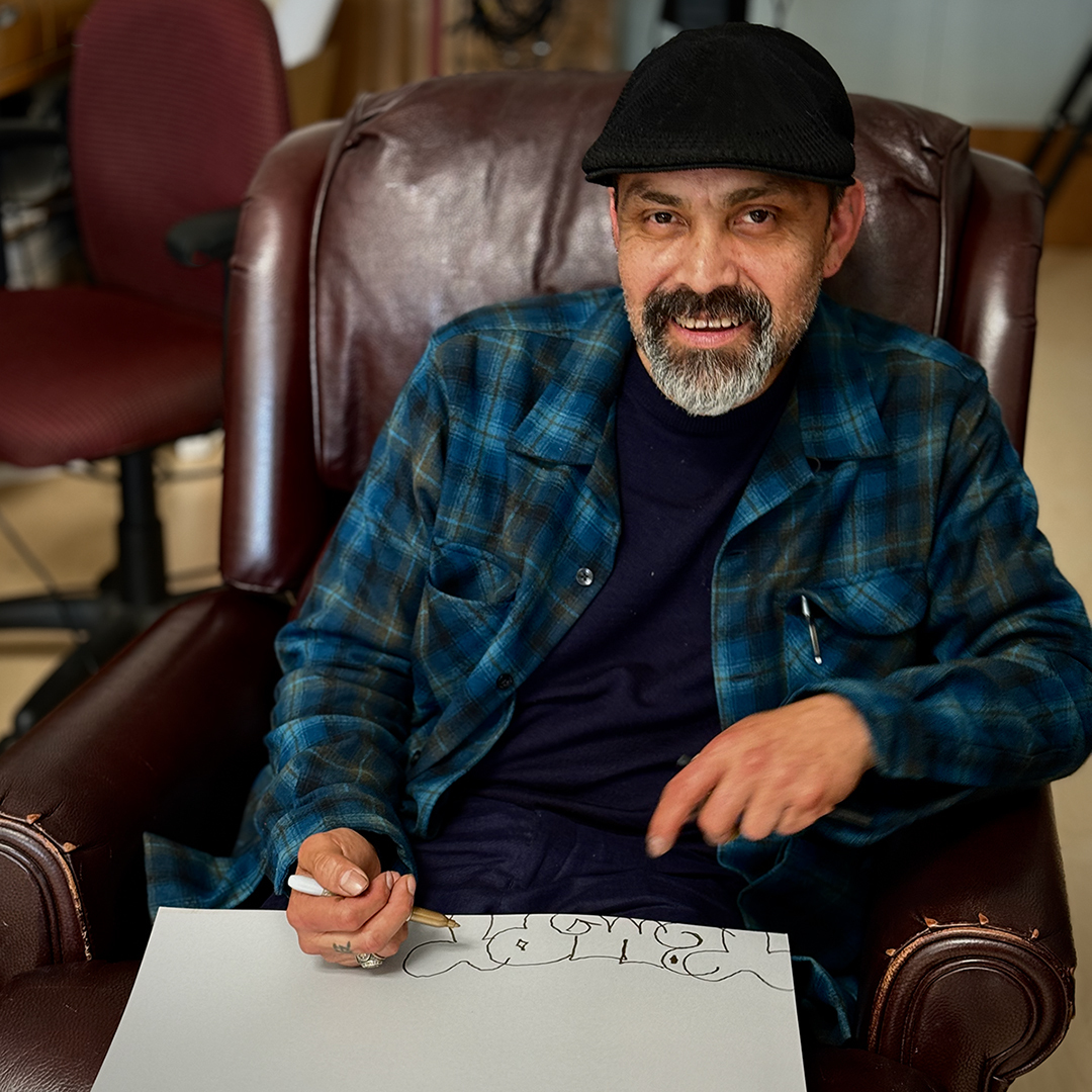 Graffiti legend PRIME going through one of his vintage Black Books at the FATHOM Art Studio