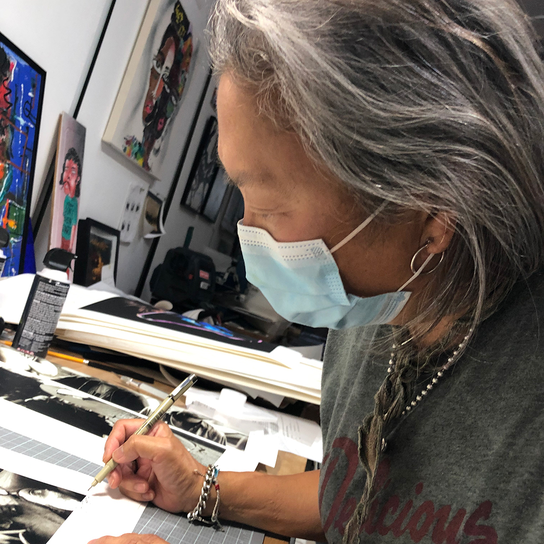 Sunny Bak signing a Beastie Boys print at AFTHOM Art Studio