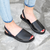 Female model wearing the Brave Soles sustainably made Avarca classic Spanish leather sandals with recycled tire soles in black color
