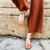 Female model wearing the Aventura leather walking sandal in natural color and sustainably made by Brave Soles