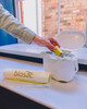 PMCBIO10 - Biosac Compostable Bin & Caddy Liner - 10 Ltr - Apple Core Being Placed in Caddy Lined with Biosac
