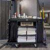 Rubbermaid Side-Load Linen Bag Fitted to Fully Loaded Housekeeping Cart in Hotel Corridor