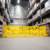 Rubbermaid FG9S1100YEL - Mobile Safety Barrier - Unfolded to Full Extension in Warehouse