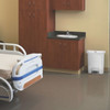 White Rubbermaid Slim Jim Front Step Pedal Bin Placed in Hospital Room Next to Sink