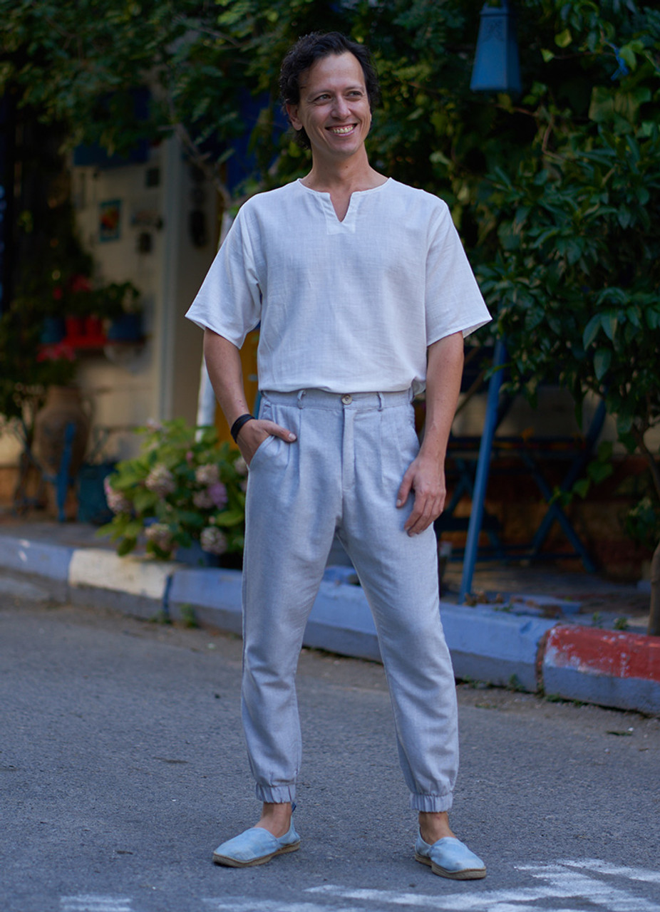 Vertical fulllength portrait of serious handsome attractive virile  masculine pensive foreigner wearing formal outfit white shirt beige pants  walking in city center architecture houses background Stock Photo  Adobe  Stock